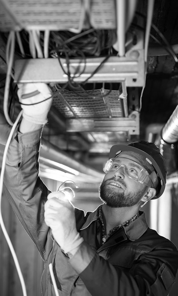 Male Worker Wearing Hard Hat  Connecting Cables